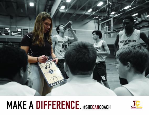 Women holding coaching board in front of team.